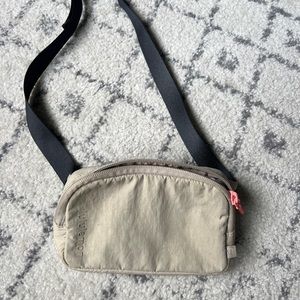 Lululemon mini belt bag. Lightly used. Light tan color. Pink lipgloss mark